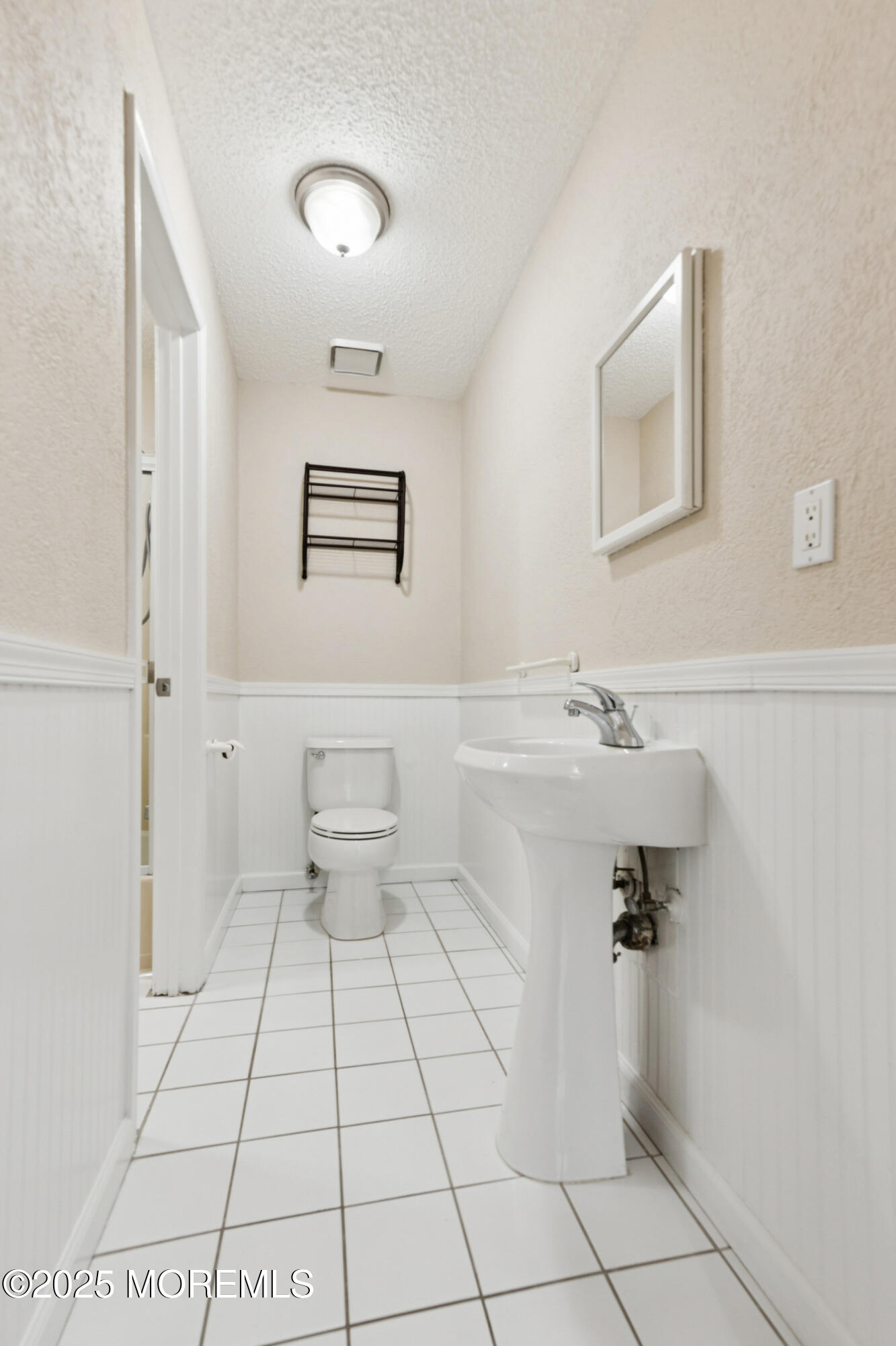 20-3 Austin Court, Unit 7 Freehold, NJ 07728 - Photo 27 of 31 a bathroom with a sink a toilet and mirror