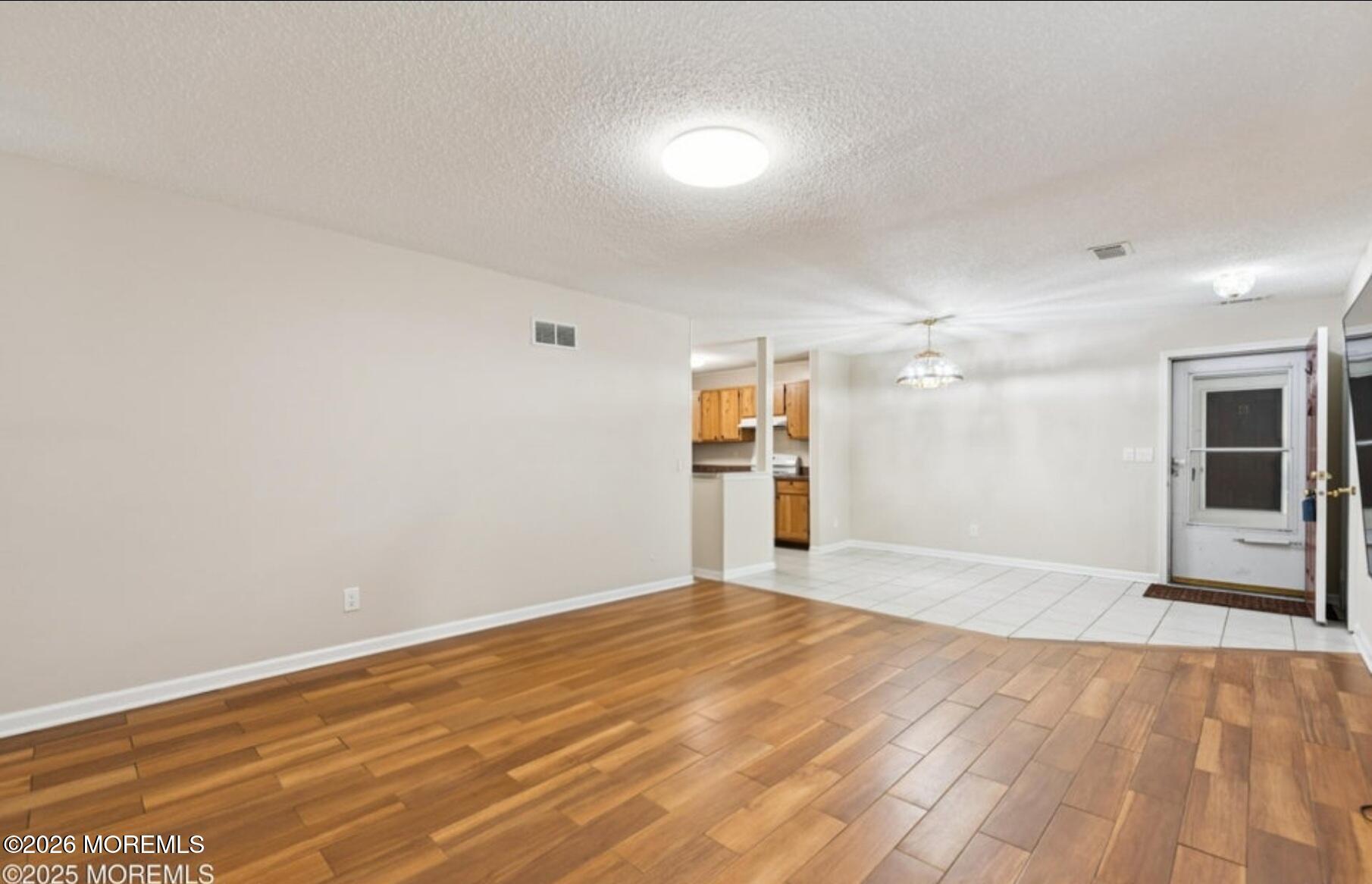 20-3 Austin Court, Unit 7 Freehold, NJ 07728 - Photo 9 of 31 a view of empty room with wooden floor
