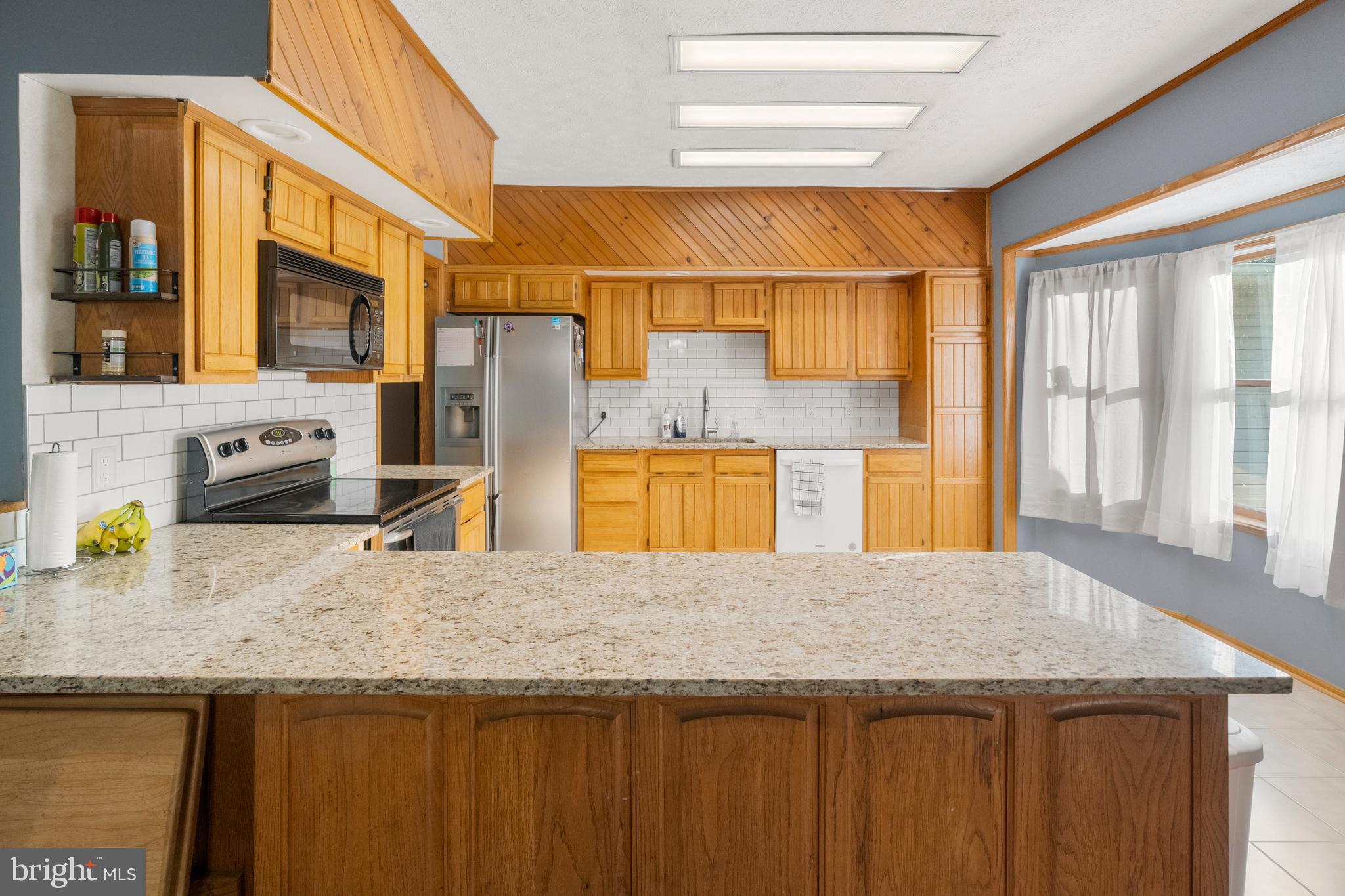 133 Roop Road Rising Sun, MD 21911 - Photo 12 of 58 a kitchen with a sink a counter top space and cabinets