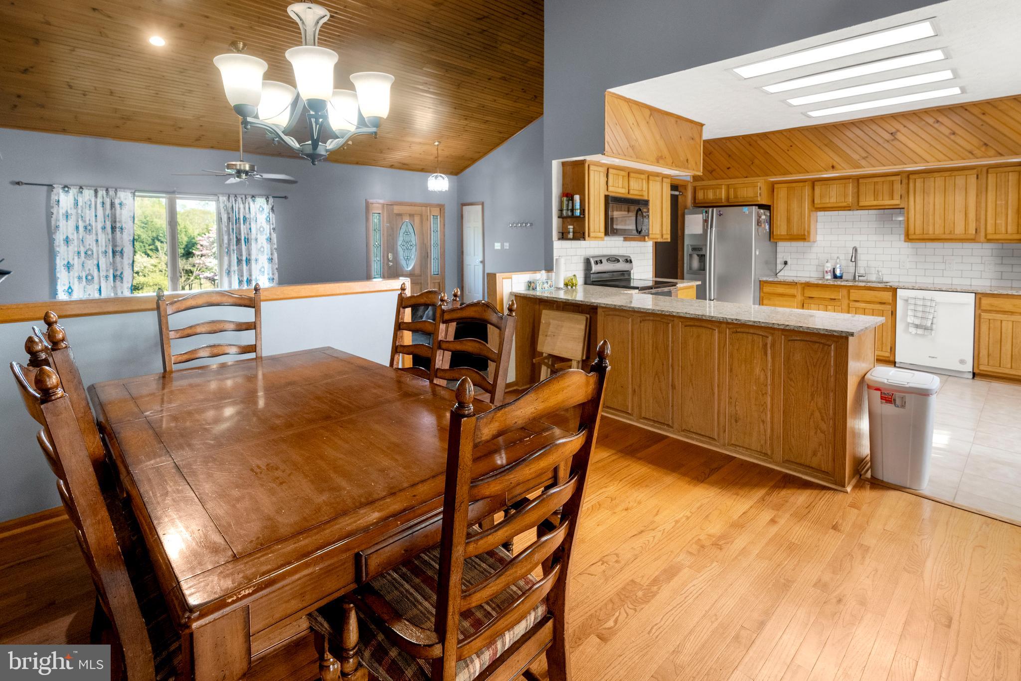 133 Roop Road Rising Sun, MD 21911 - Photo 14 of 58 a dining room with stainless steel appliances a table and chairs in it