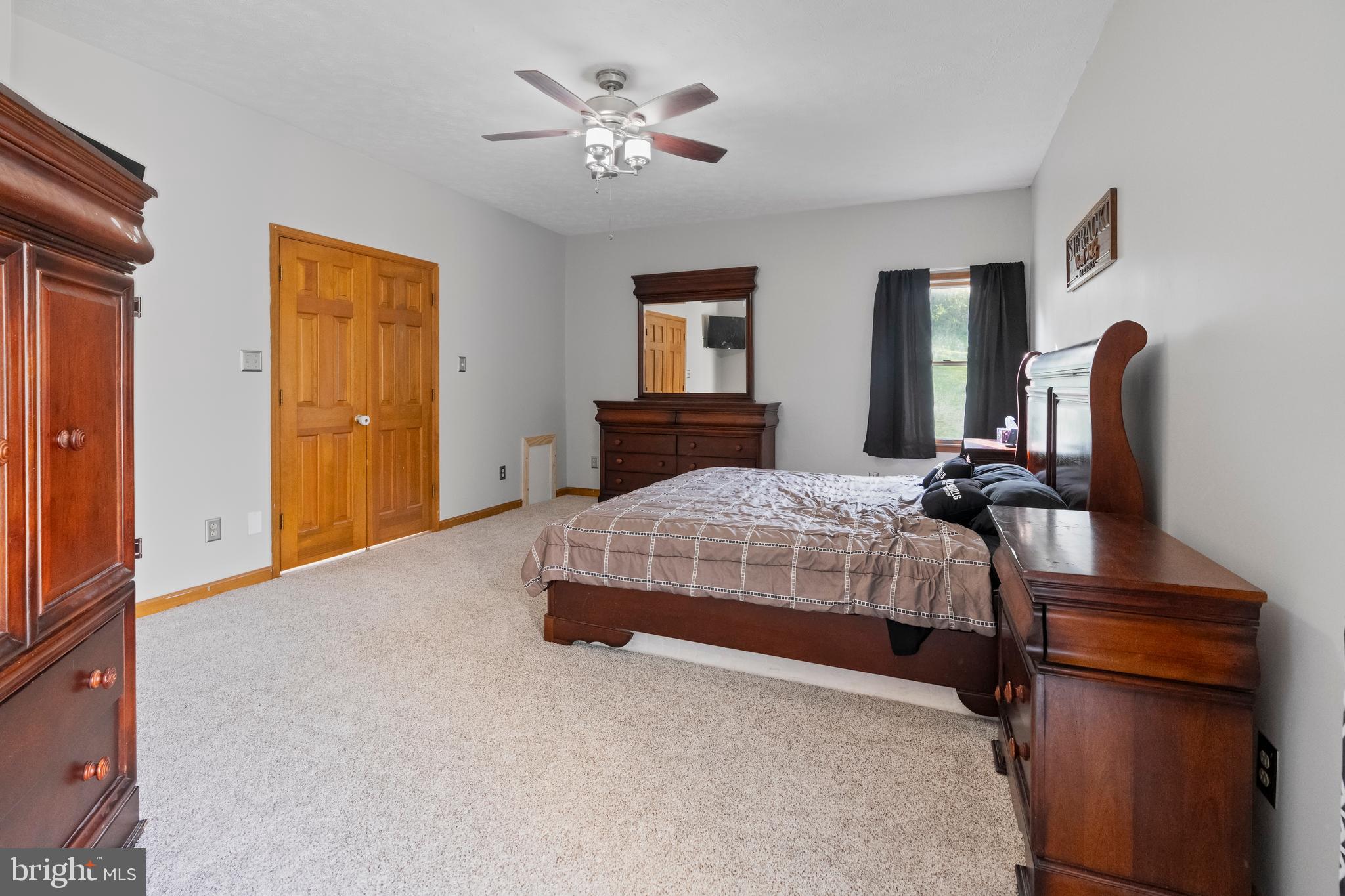 133 Roop Road Rising Sun, MD 21911 - Photo 20 of 58 a bedroom with a bed and a chandelier