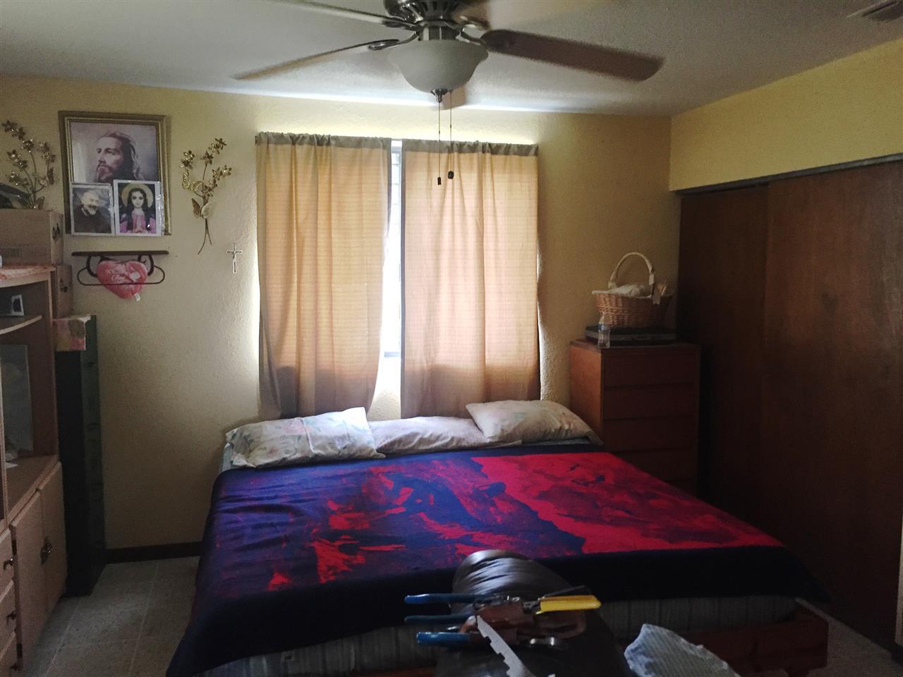 379 Well Lane Laredo, TX 78045 - Photo 8 of 20 a bedroom with a bed and a chandelier