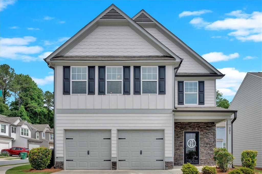 a front view of a house with garden