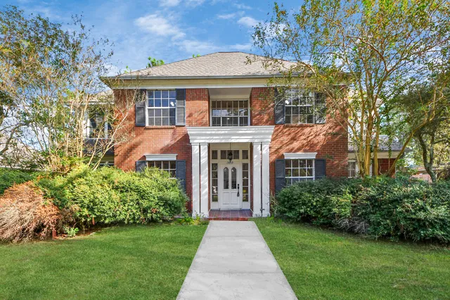 a front view of a house with a garden