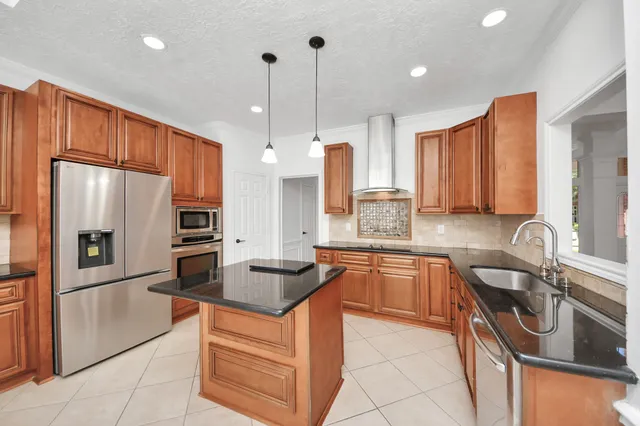 a kitchen with granite countertop a sink and cabinets