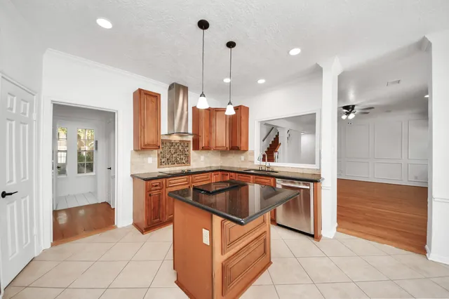 a kitchen with stainless steel appliances granite countertop a sink and cabinets