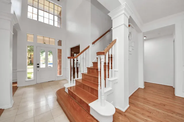 a view of entryway and hall with wooden floor