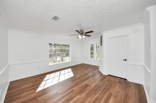 a view of a house with backyard and a tree