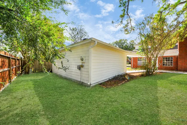 an aerial view of a house with a yard and garden