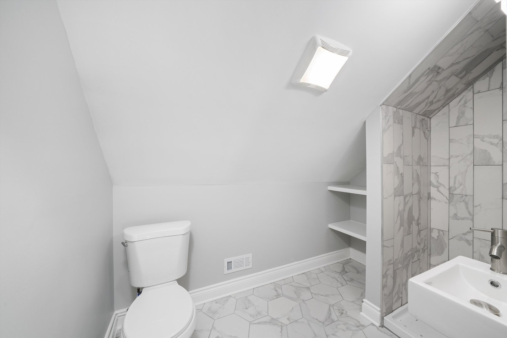 5237 Long Avenue Chicago, IL 60638 - Photo 24 of 41 a white toilet sitting next to a bathroom sink and tub