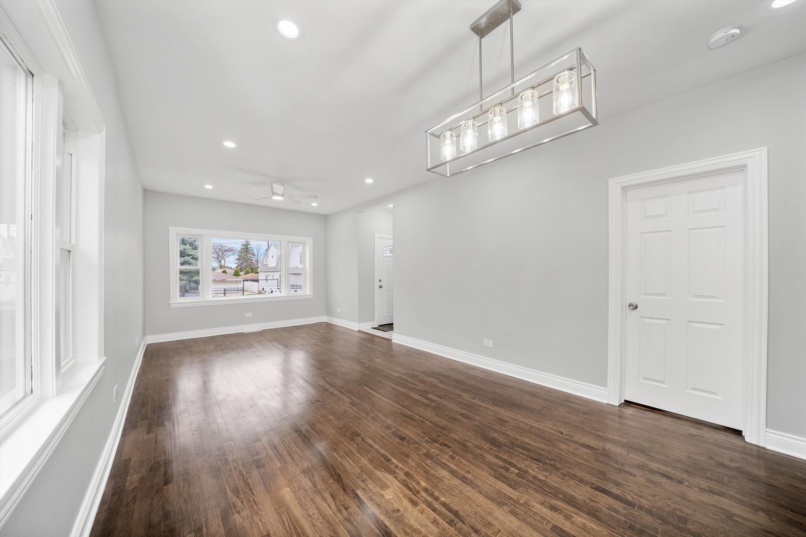5237 Long Avenue Chicago, IL 60638 - Photo 6 of 41 an empty room with wooden floor mirror and windows