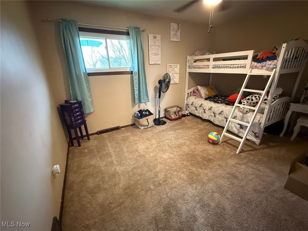 10719 Johnnycake Ridge Road Painesville, OH 44077 - Photo 13 of 21 Unfurnished bedroom featuring carpet and a ceiling fan