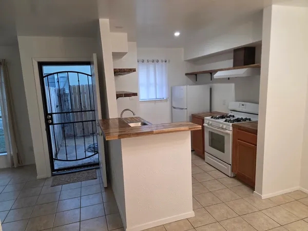 a kitchen with stainless steel appliances granite countertop a sink and a stove