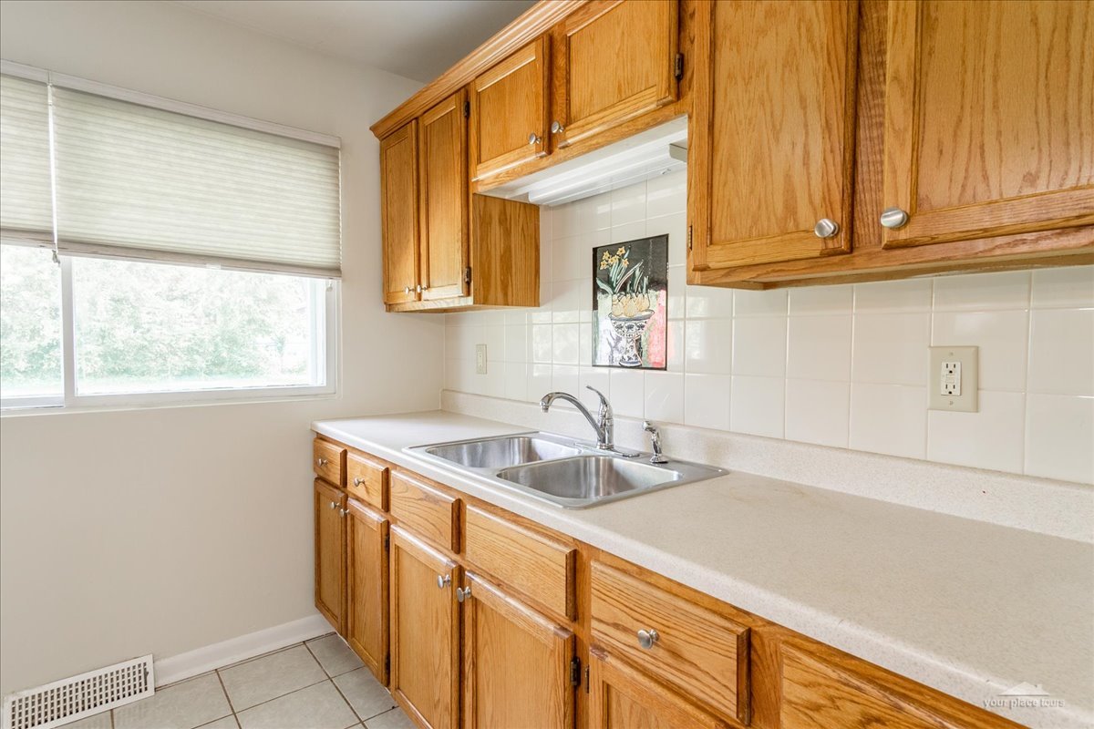 28 Hampton Road Montgomery, IL 60538 - Photo 12 of 27 a kitchen with stainless steel appliances granite countertop a sink and a white cabinets