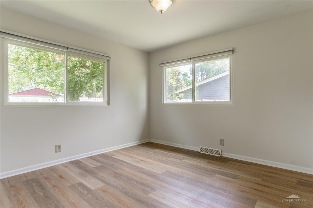 28 Hampton Road Montgomery, IL 60538 - Photo 14 of 27 an empty room with wooden floor and windows