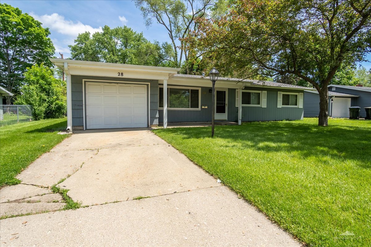 28 Hampton Road Montgomery, IL 60538 - Photo 3 of 27 a front view of a house with a garden and trees