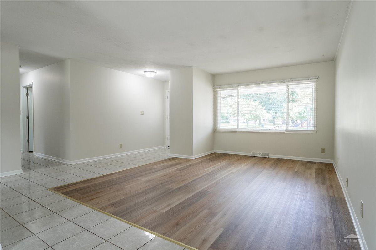 28 Hampton Road Montgomery, IL 60538 - Photo 6 of 27 an empty room with wooden floor and windows