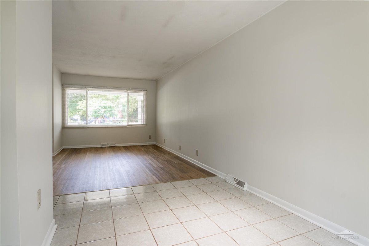 28 Hampton Road Montgomery, IL 60538 - Photo 7 of 27 an empty room with wooden floor and windows