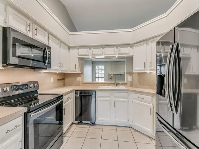 a kitchen with a stove sink and refrigerator