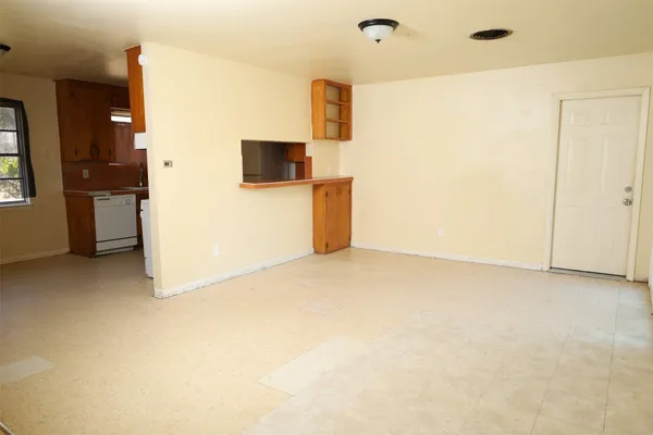 a view of a kitchen with a sink and a refrigerator
