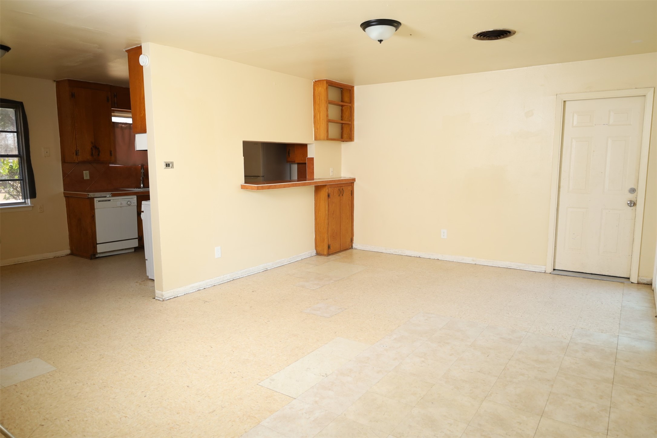 13207 Santa Teresa Road Houston, TX 77045 - Photo 4 of 20 a view of a kitchen with a sink and a refrigerator