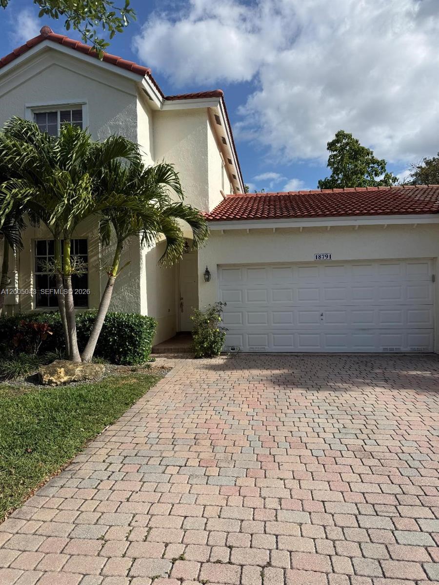 18791 Southwest 25th Court Miramar, FL 33029 - Photo 2 of 4 a front view of a house with a yard