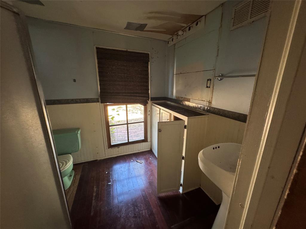 114 Main Street Haslet, TX 76052 - Photo 11 of 14 a view of walk in closet with wooden floor and chair