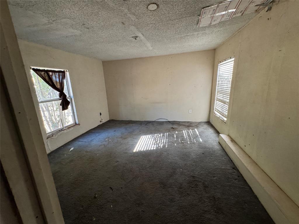 114 Main Street Haslet, TX 76052 - Photo 12 of 14 an empty room with windows