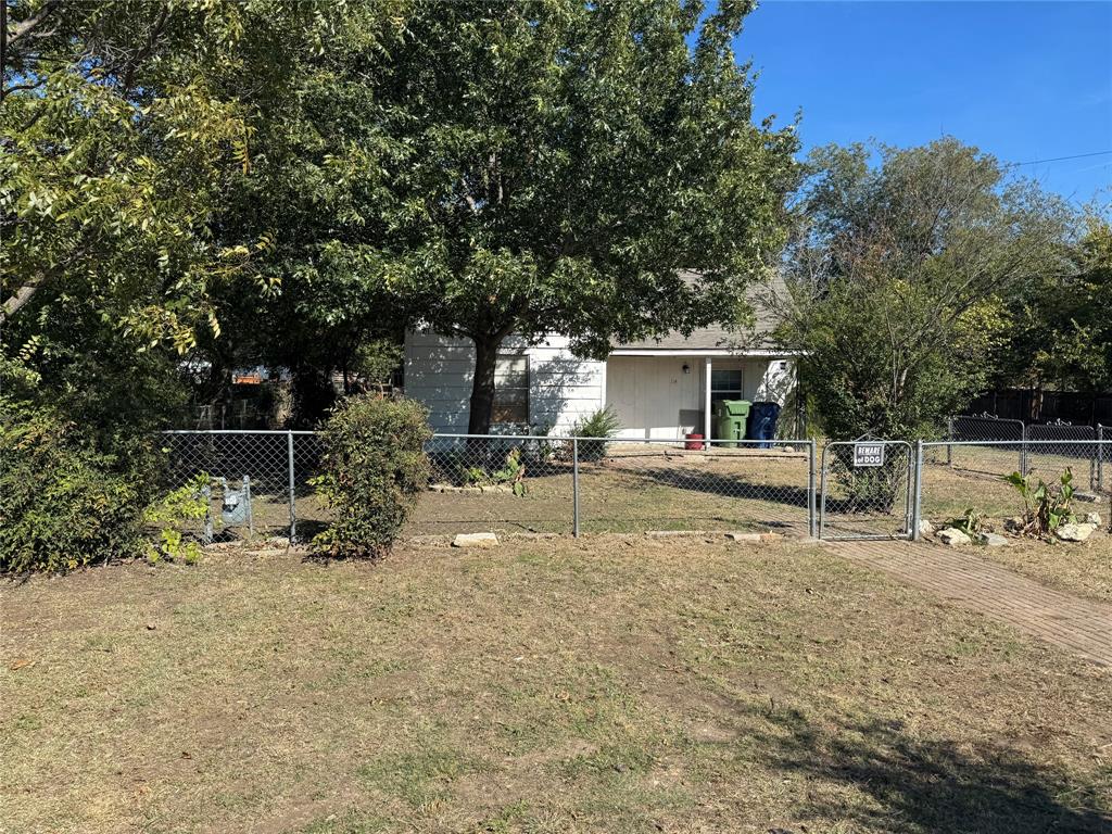 114 Main Street Haslet, TX 76052 - Photo 2 of 14 a backyard of a house with lots of green space