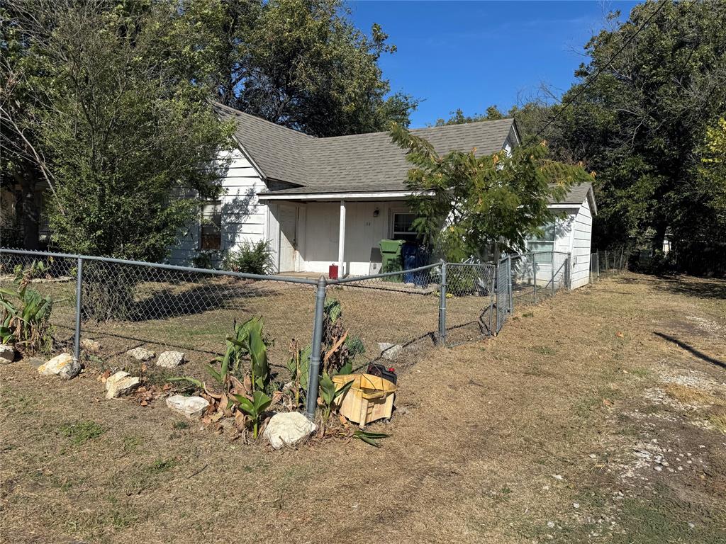 114 Main Street Haslet, TX 76052 - Photo 3 of 14 a view of a backyard with plants and trees