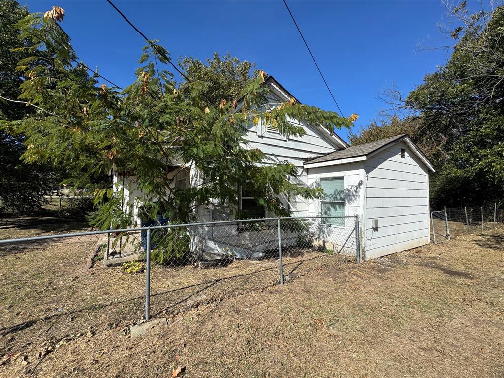 114 Main Street Haslet, TX 76052 - Photo 4 of 14 a backyard of a house with table and chairs