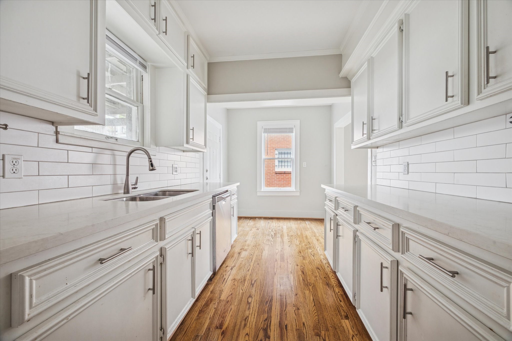 2510 Kingston Street, Unit 1 Houston, TX 77019 - Photo 7 of 12 a kitchen with a sink stove and cabinets