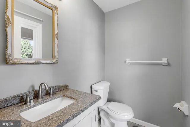 an empty room with a ceiling fan and a window