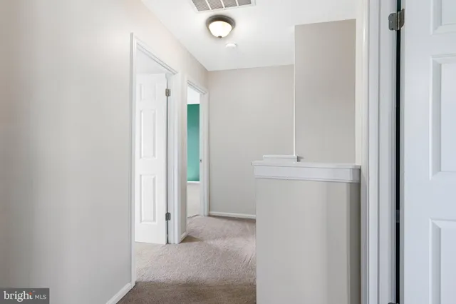 an empty room with a window and fan