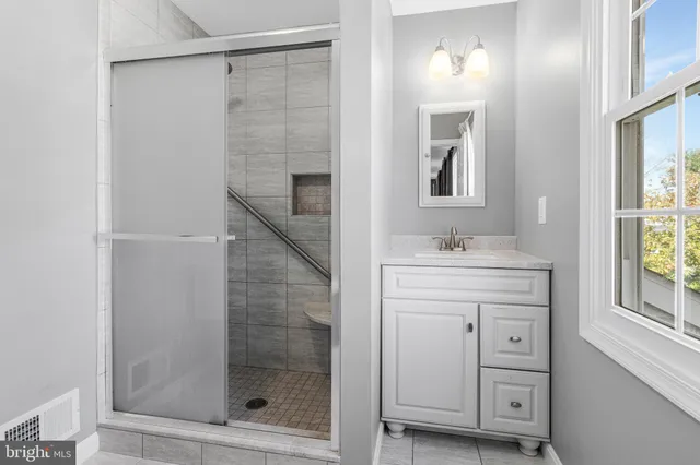 a view of an empty room with empty room and wooden floor