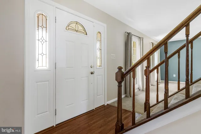 a view of staircase with railing and a window