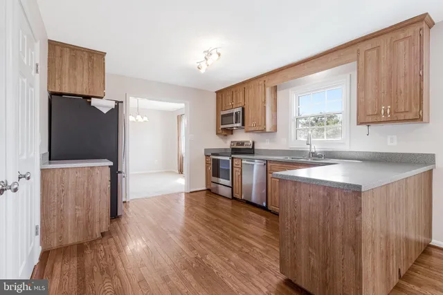 a view of a livingroom with wooden floor and a fireplace