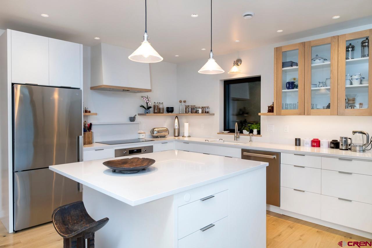 624 Nicholson Lake Ridge Road Crested Butte, CO 81224 - Photo 13 of 43 a kitchen with kitchen island a sink a stove and refrigerator