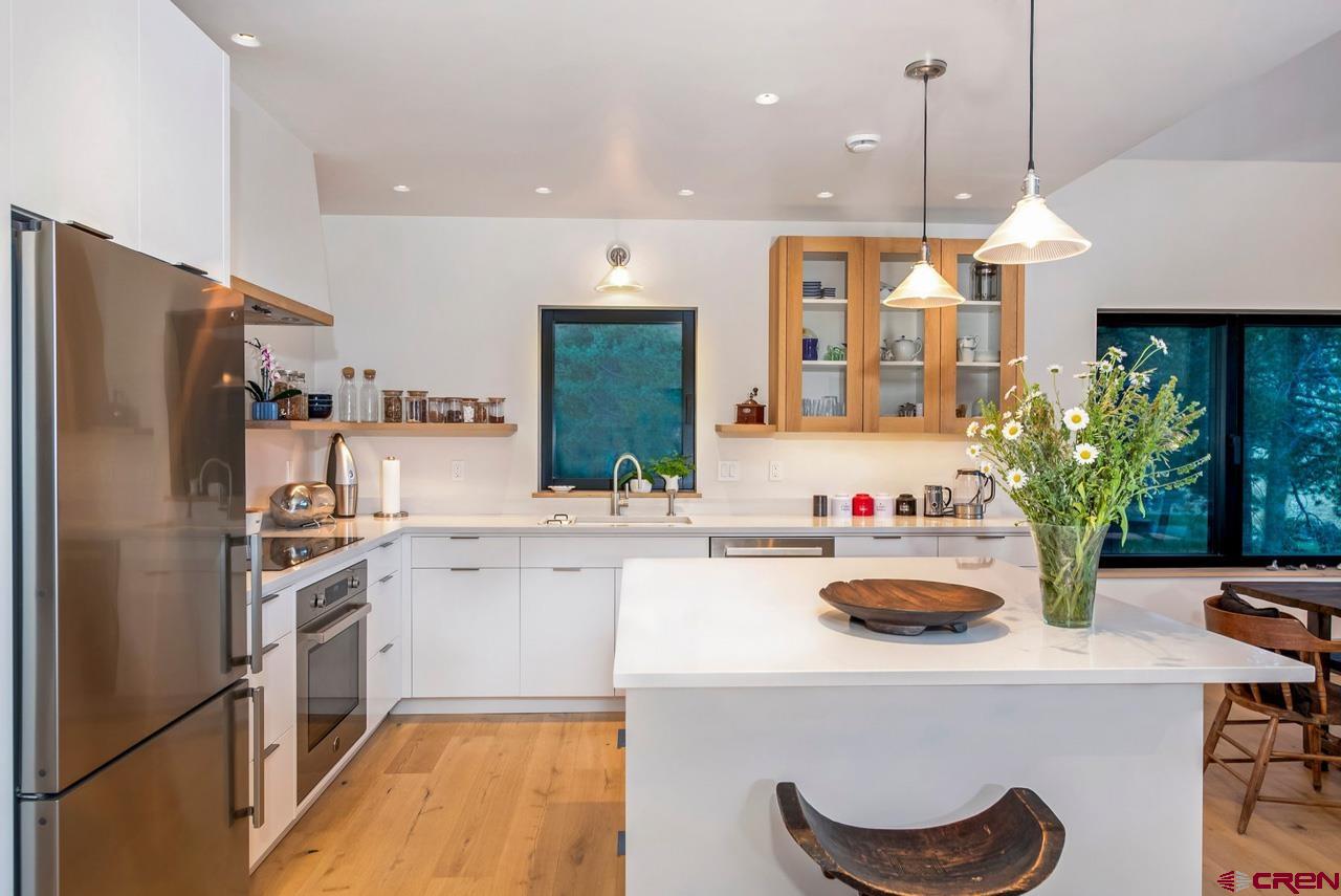 624 Nicholson Lake Ridge Road Crested Butte, CO 81224 - Photo 14 of 43 a kitchen with kitchen island a stove a sink and a refrigerator