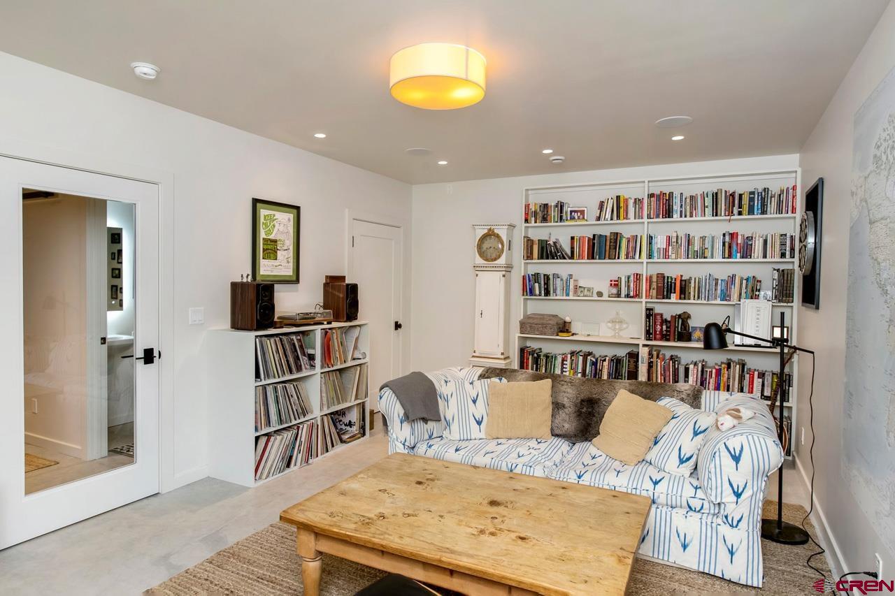 624 Nicholson Lake Ridge Road Crested Butte, CO 81224 - Photo 26 of 43 a living room with furniture and a book shelf