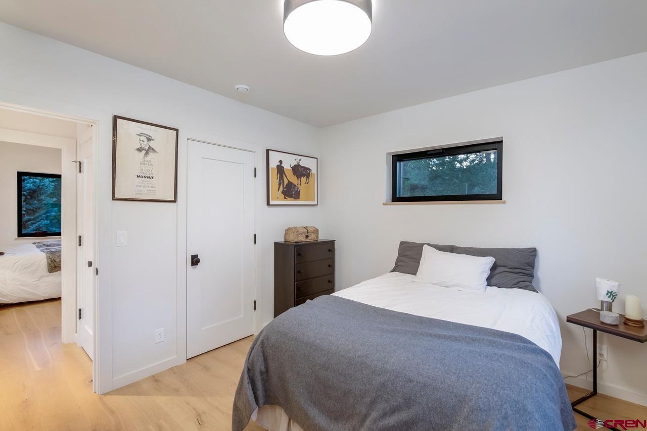 624 Nicholson Lake Ridge Road Crested Butte, CO 81224 - Photo 27 of 43 a bedroom with a bed and a painting on the wall