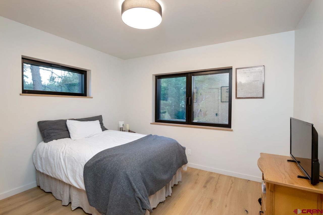624 Nicholson Lake Ridge Road Crested Butte, CO 81224 - Photo 29 of 43 a bedroom with a bed and a window