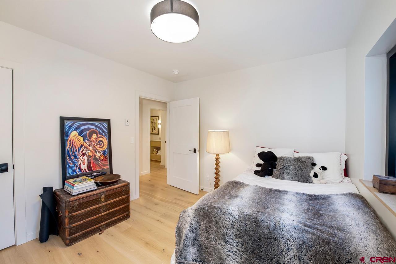 624 Nicholson Lake Ridge Road Crested Butte, CO 81224 - Photo 30 of 43 a bedroom with a bed and dresser