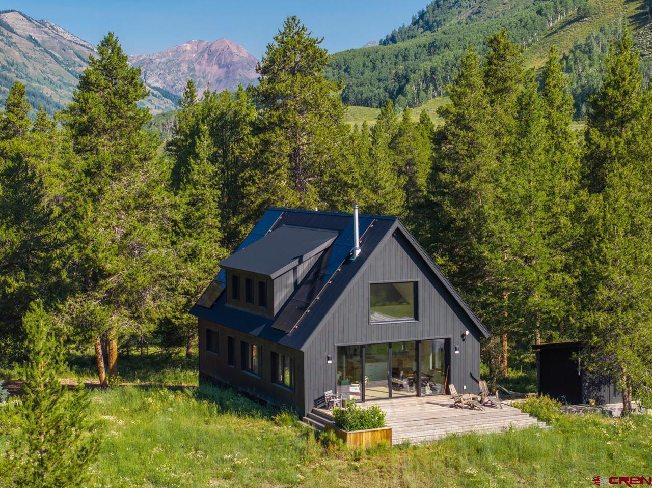 624 Nicholson Lake Ridge Road Crested Butte, CO 81224 - Photo 38 of 43 a front view of a house with yard and green space
