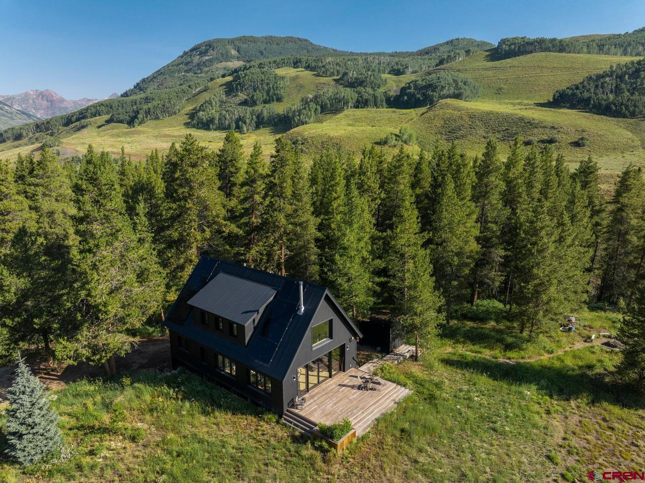 624 Nicholson Lake Ridge Road Crested Butte, CO 81224 - Photo 40 of 43 a view of a small house with a garden