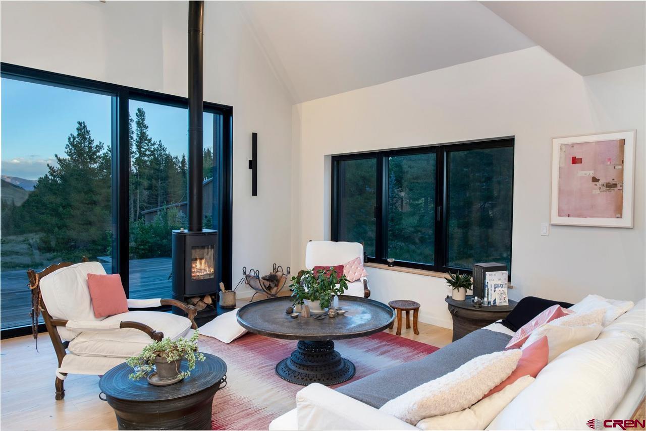 624 Nicholson Lake Ridge Road Crested Butte, CO 81224 - Photo 7 of 43 a living room with furniture and a large window