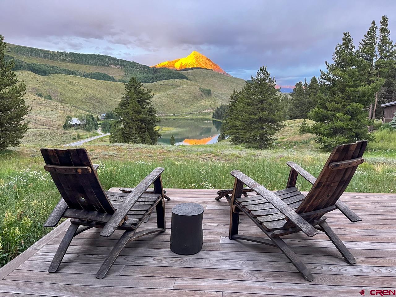 624 Nicholson Lake Ridge Road Crested Butte, CO 81224 - Photo 8 of 43 a view of a lake with table and chairs