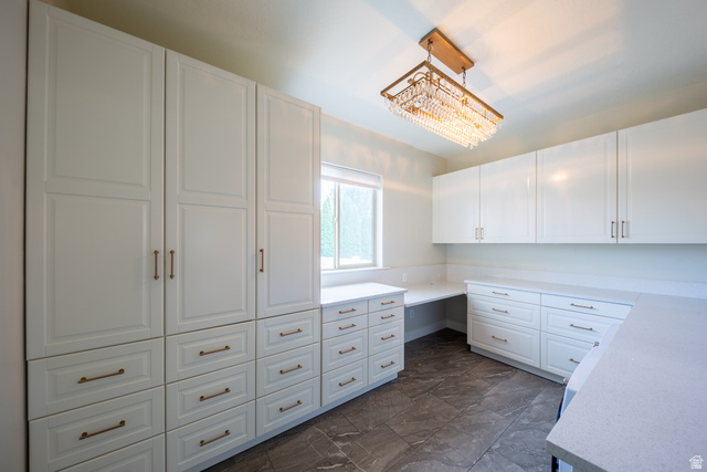 868 Braddock Lane Alpine, UT 84004 - Photo 17 of 64 Spacious room featuring extensive white cabinetry with varied storage options, including full-height pantry-style units and multiple drawers