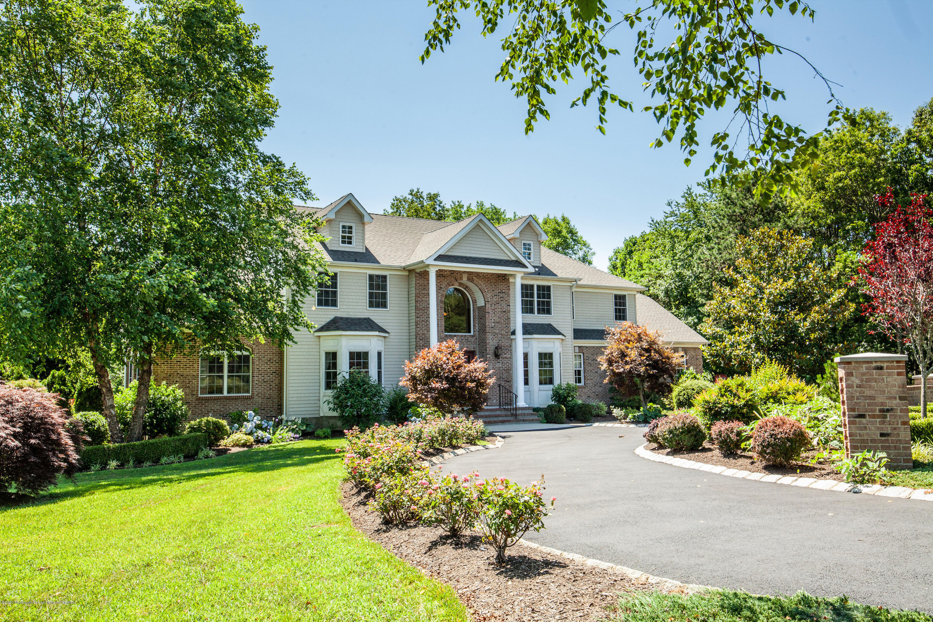 2228 Christopher Way Wall, NJ 07719 - Photo 1 of 25 a front view of a house with a porch and a yard
