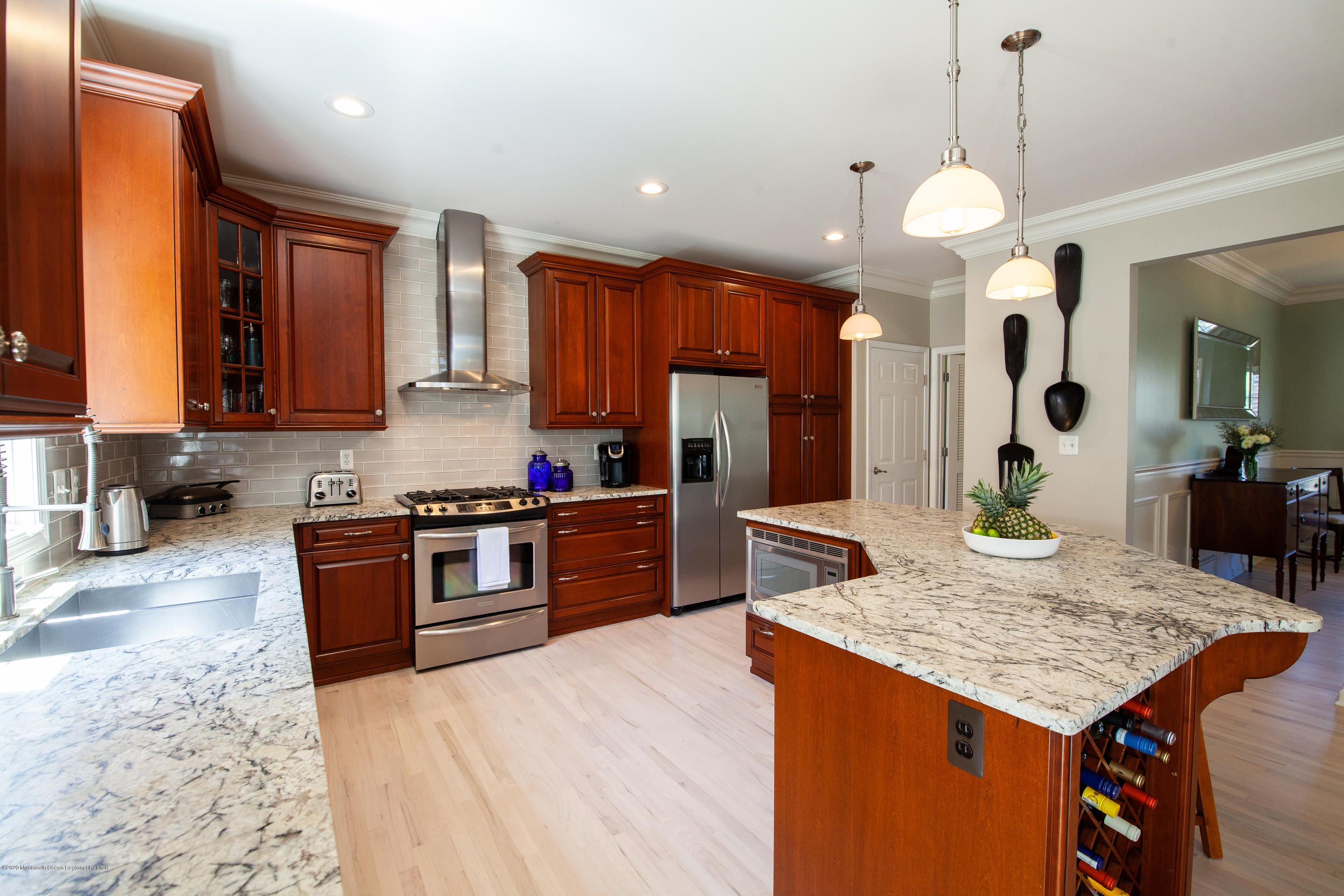 2228 Christopher Way Wall, NJ 07719 - Photo 5 of 25 a kitchen with a stove a kitchen island a refrigerator and a stove